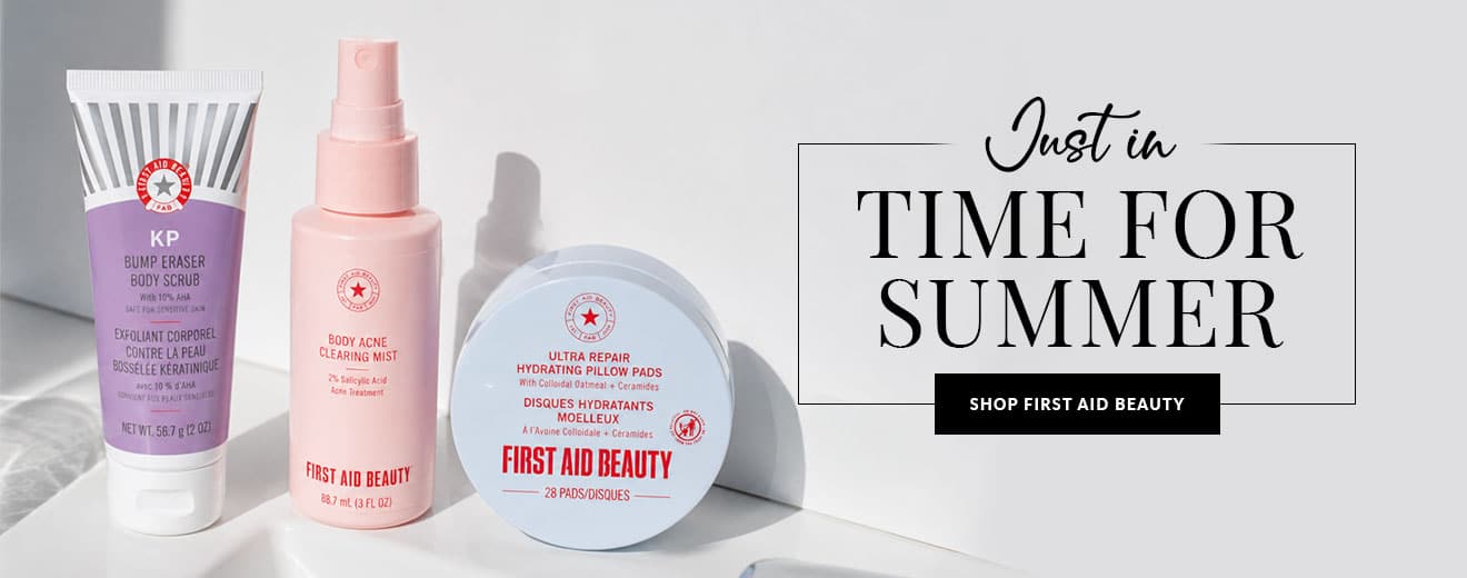 Three First Aid Beauty skincare products (purple Bump Eraser Scrub, pink Body Acne Clearing Mist, blue round Hydrating Pads) on a white surface beside a 'Just in Time for Summer' banner area.